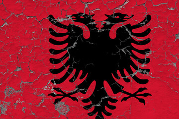 Albania flag close up grungy, damaged and weathered on wall peeling off paint to see inside surface. Vintage concept.