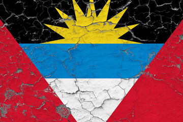 Antigua and Barbuda flag close up grungy, damaged and weathered on wall peeling off paint to see inside surface. Vintage concept.