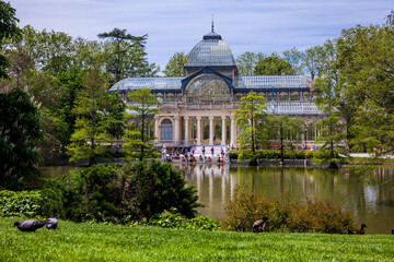 Fototapeta na wymiar View of the beautiful Palacio de Cristal a conservatory located in El Retiro Park built in 1887 in Madrid