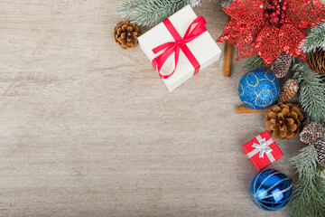 Christmas holidays composition with decorations, presents, tree balls, pine cones and plants on white wooden board background with copy space for your text. Flat lay, top view