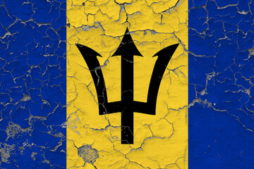 Barbados flag close up grungy, damaged and weathered on wall peeling off paint to see inside...