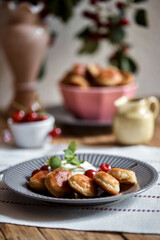 Mini-pancakes, pancakes with cherries and sour cream. Homemade baking. tiny pancakes, ceral pancake