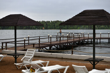 landscape with a pier on the river and forest