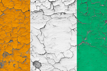 Cote D'Ivoire flag close up grungy, damaged and weathered on wall peeling off paint to see inside surface. Vintage concept.