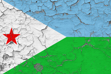 Djibouti flag close up grungy, damaged and weathered on wall peeling off paint to see inside surface. Vintage concept.