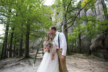 Stylish groom and pretty bride on wedding day