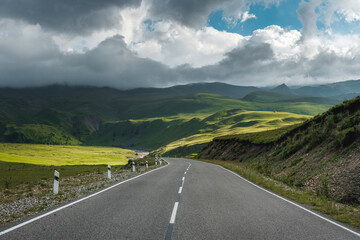 Asphalt road high in the mountains, against the backdrop of a beautiful landscape. The concept of...