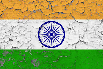 India flag close up grungy, damaged and weathered on wall peeling off paint to see inside surface. Vintage concept.