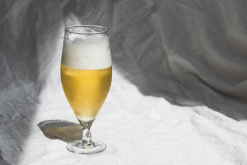 Glass with cold refreshing beer on a white background, in the art style. The concept of relaxation,...