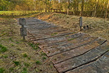 Reconstruction of a prehistoric Iron Age boardwalk with ritual wooden figures in the moorland of Wittemoor (district Wesermarsch, Germany) on a sunny spring day