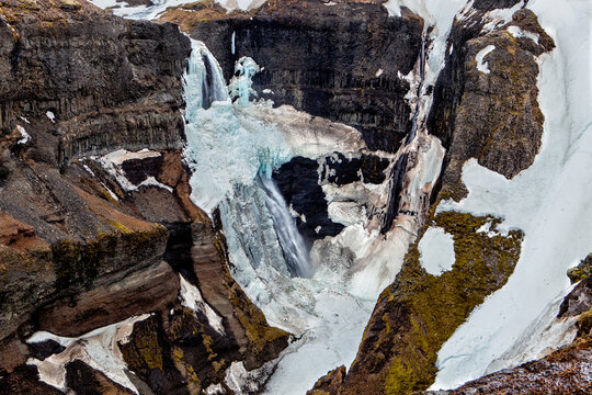 The waterfall surrounded by ice and snow