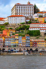 Fototapeta premium View across the Douro onto facades of traditional houses with azulejo tile in the Ribeira neighborhood Porto, Portugal