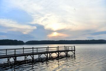 Fototapeta na wymiar river pier with lanterns at sunrise