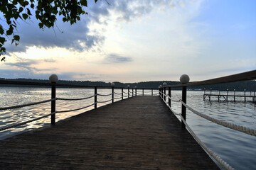 Fototapeta na wymiar river pier with lanterns at sunrise