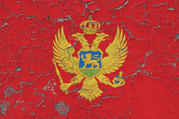 Montenegro flag close up grungy, damaged and weathered on wall peeling off paint to see inside surface. Vintage concept.