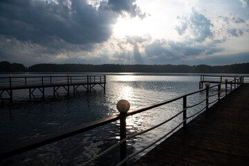 Obraz premium river pier with lanterns at sunrise