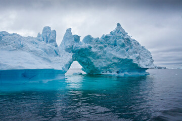 Fototapeta na wymiar Iceberg arch in Disko Bay, Ilulissat, West Greenland
