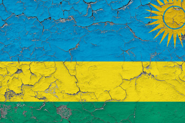 Rwanda flag close up grungy, damaged and weathered on wall peeling off paint to see inside surface. Vintage concept.