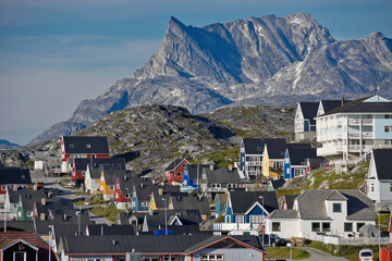 Rugged Mount Sermitsiaq looms above a colorful residential area in Nuuk, Greenland © Michele Burgess