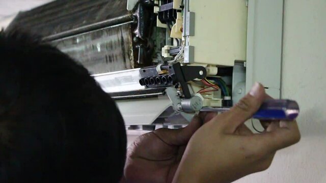man working in factory with home air condoning cleaning 