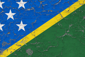Solomon Islands flag close up grungy, damaged and weathered on wall peeling off paint to see inside...