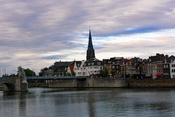 Fototapeta premium Panorama of Maastricht from river Maas or Meuse. The city is a capital of Limburg province and one of popular tourist destinations