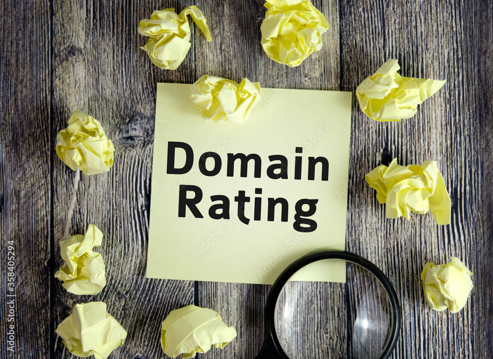 Poster domain rating seo concept - text on yellow note sheets on a dark wooden background with crumpled she