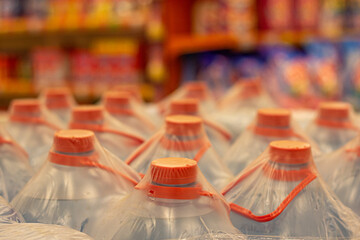 Plastic water bottles with red caps in a store.