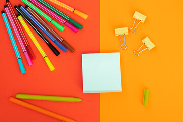 Minimum set of school and office supplies on bright blue (turquoise) and orange background: pen,...