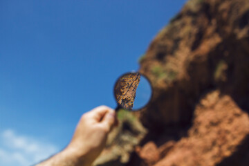 Magnifying glass looks at mountains