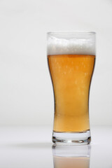 Large glass of beer on a light background