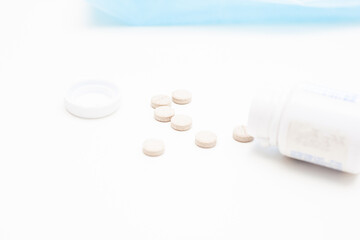 medical jars with pills on white table