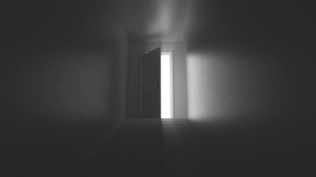 shine of an open door with steps in a dark corridor