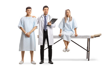 Obraz premium Young male doctor holding a young male patient on the shoulder and a female patient sitting on a bed