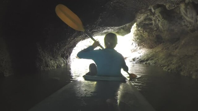 Woman paddles kayak and explores the Ha Long Bay in Vietnam