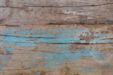 old wooden board with cracks and spots of blue paint. rough surface texture