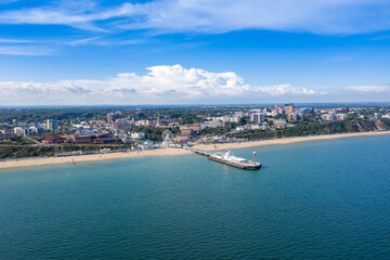 Naklejka na ściany i meble Aerial drone photo of the Bournemouth beach, Observation Wheel and Pier on a beautiful sunny summers day with lots of people relaxing and sunbathing on the British Dorset sandy beach and ocean