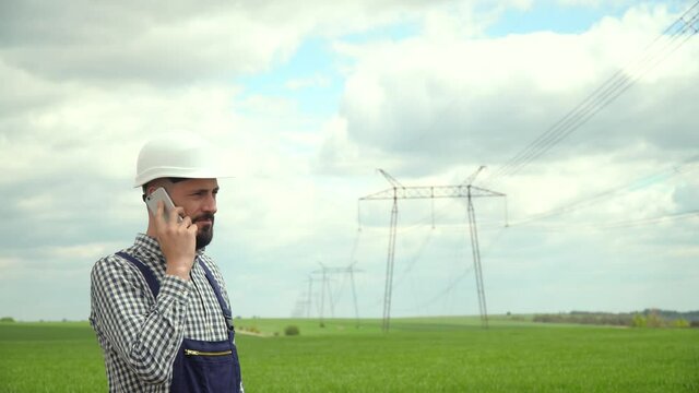 Engineer working near transmission lines. Engineer working near transmission lines. Transmission towers