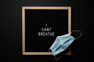 Black Lives Matter Protest Sign on a black background with covid fask mask