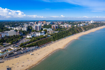 Fototapeta premium Aerial drone photo of the Bournemouth beach and town centre on a beautiful sunny summers day showing people on the sandy beach on the British sunny beach