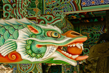 A colorful dragon and intricate artwork decorate the bell pavilion at Haeinsa Buddhist temple, ...