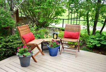 Outdoor patio seating in beautiful tranquil backyard sanctuary with beautiful landscaping for...