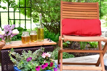 Outdoor patio seating in beautiful tranquil backyard sanctuary with beautiful landscaping for mindful relaxation on a warm summer afternoon during quarantine stay at home vacation