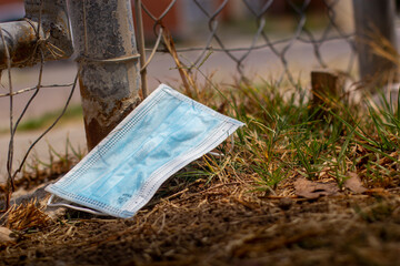 Disposable face mask thrown on the street during the Covid-19 pandemic