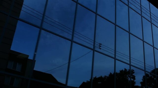 Toronto, Canada - June 12, 2018 - Modern glass building with reflection and electric wires on downtown with halted car and vehicle