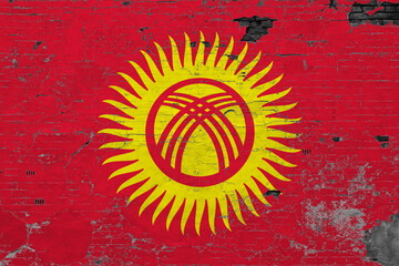 Kyrgyzstan flag on grunge scratched concrete surface. National vintage background. Retro wall...