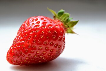 Macro  of the garden strawberry (Fragaria ananassa). Closeup of fresh red and ripe strawberry. Freshly harvested strawberry  texture. Selective focus.