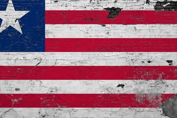 Liberia flag on grunge scratched concrete surface. National vintage background. Retro wall concept.