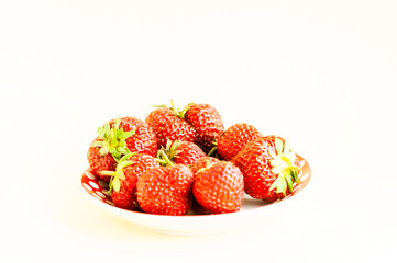 strawberries on a plate on a light background. place for text
