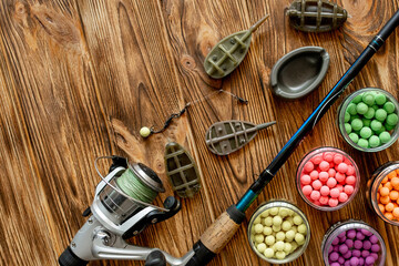 Accessories for carp fishing and fishing baits on wooden planks with copy space
